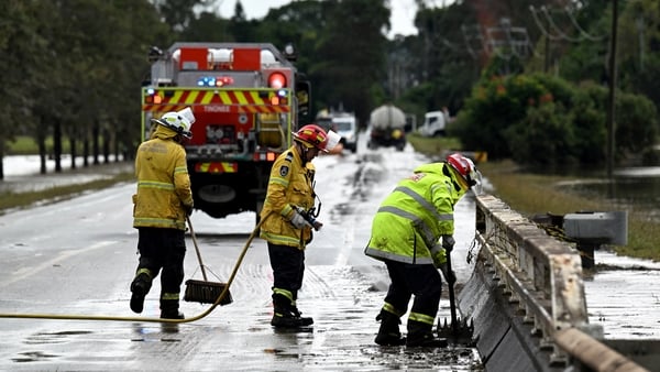 Fire Brigade officials clear silt as floodwaters recede