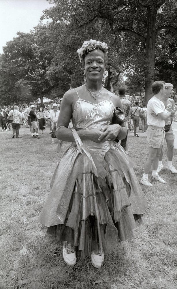 A black and white photo of Marsha P. Johnson, a gay liberation activist