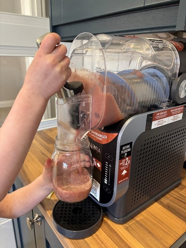 a person using a slushie machine
