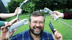 Joe Duffy posing with telephone handsets to publicise Liveline, 2001