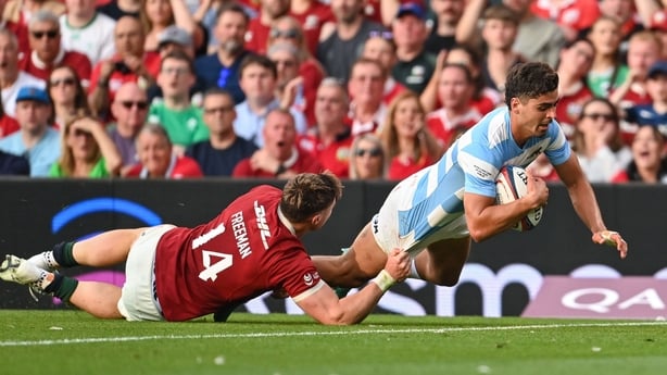 Argentina's Ignacio Mendy crosses for opening try of the game despite the efforts of Lions winger Tommy Freeman