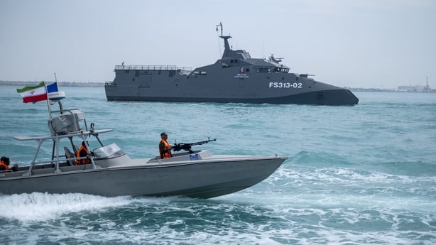 The IRGC Navy Martyr Hassan Bagheri warship and an IRGC speed boat are sailing along the Persian Gulf during the IRGC marine parade, which is commemorating the Persian Gulf National Day, near the Bushehr nuclear power plant in the seaport city of Bushehr, Bushehr province, in the south of Iran, on A