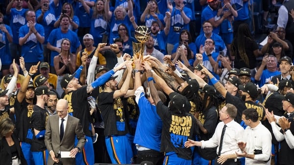 Oklahoma City Thunder players celebrate with the Larry O'Brien trophy