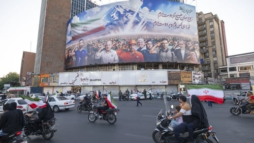 A huge billboard featuring a symbolic image of Iranian people, military commanders, and nuclear scientists killed in Israeli attacks is seen in Tehran