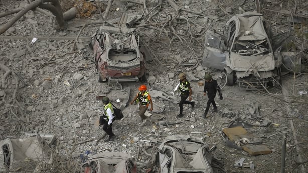 BEERSHEBA, ISRAEL - JUNE 24: Emergency responders walk amid damaged cars at a building where at least four people died in a missile strike on June 24, 2025 in Beersheba, Israel. According to Israeli authorities, Iran launched a barrage of missiles in the early hours this morning, before the start of